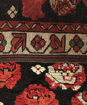 Close-up of a patterned fabric with floral designs and intricate details.