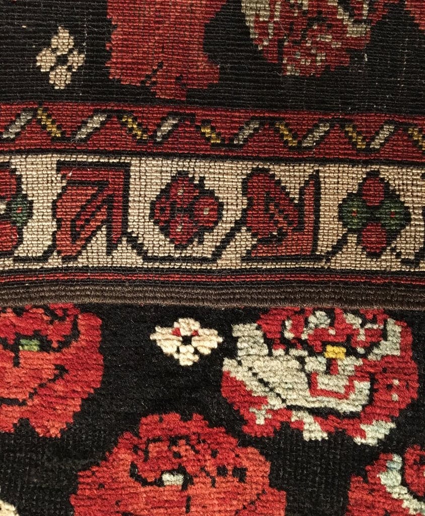 Close-up of a patterned fabric with floral designs and intricate details.